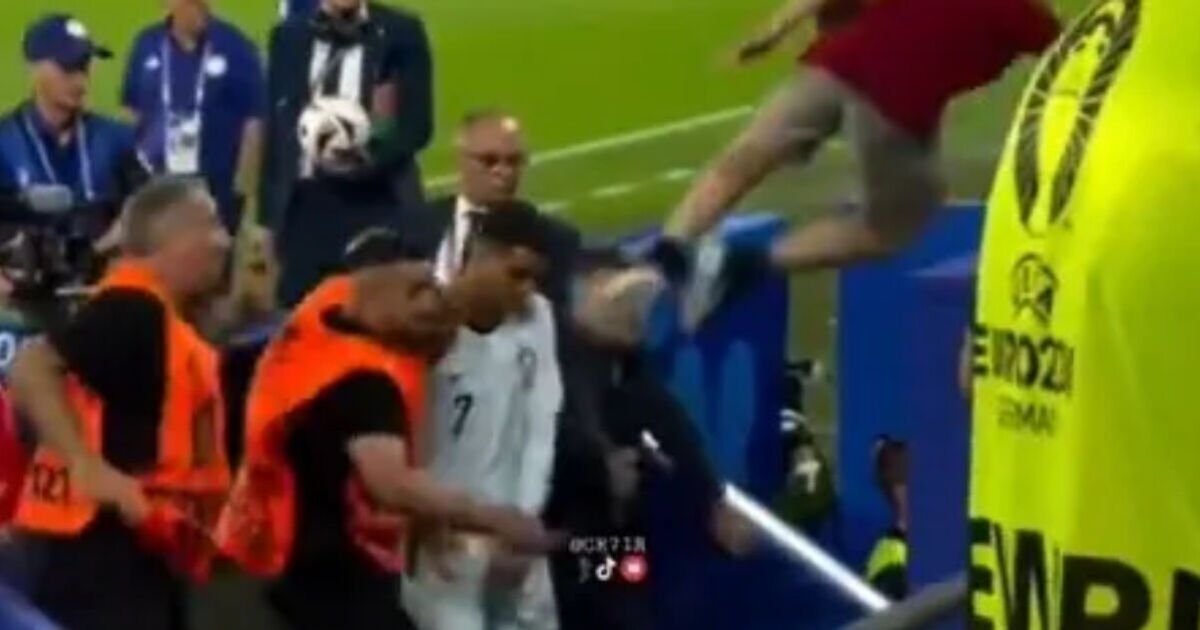 Cristiano Ronaldo narrowly avoids being two-footed in the face by fan who leapt from crowd