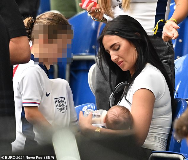 Annie Kilner feeds baby Rezon while cheering England from the stands after ‘catching private jet to Germany’… as friends claim she is ‘surrounded by love’ from fellow WAGS