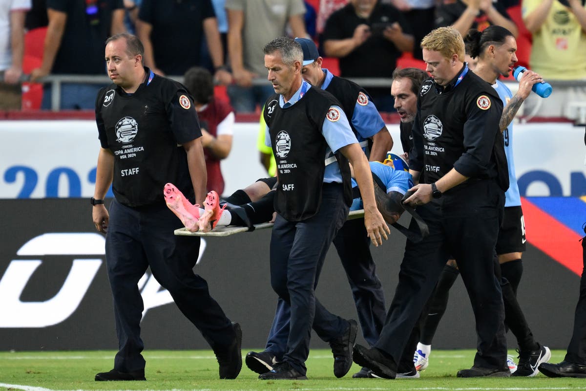 Uruguay player carried off after head-on smash with US rival during Copa America game